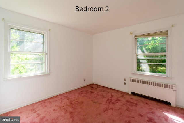 209 Berkshire Ave, Linwood, NJ 08221 - carpeted empty room with radiator heating unit, healthy amount of natural light, and baseboards