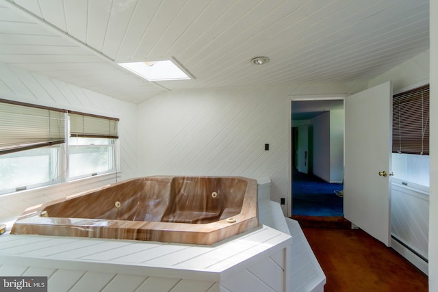 209 Berkshire Ave, Linwood, NJ 08221 - bathroom featuring a baseboard radiator, a jetted tub, a skylight, and wood ceiling