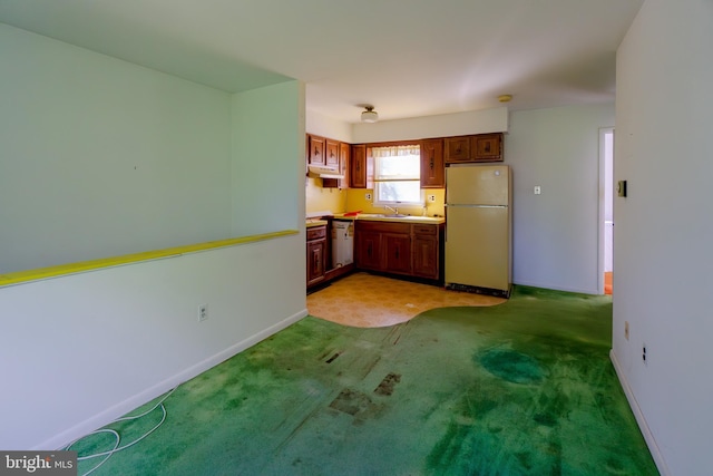 209 Berkshire Ave, Linwood, NJ 08221 - kitchen featuring freestanding refrigerator, a sink, under cabinet range hood, baseboards, and light carpet