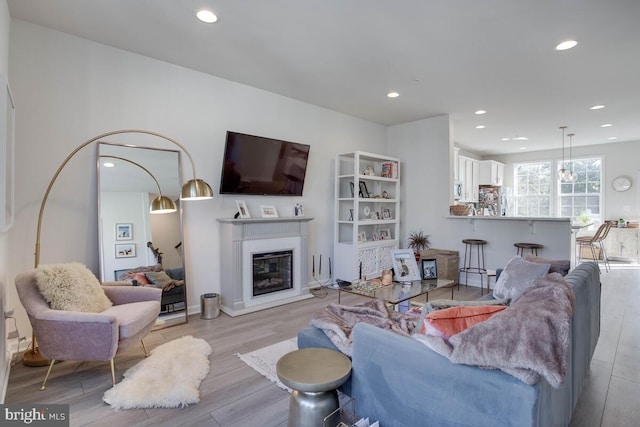 3402 Gentle Breeze Dr, Upper Marlboro, MD 20772 - living area featuring light wood finished floors, recessed lighting, and a glass covered fireplace