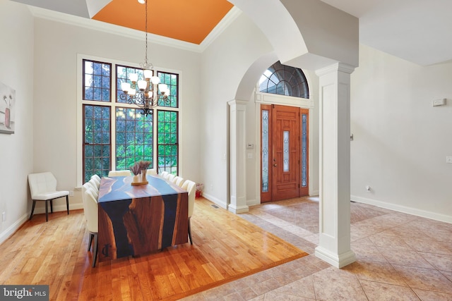 25 Mariner Ct, Ridgeley, WV 26753 - dining area featuring ornamental molding, a chandelier, arched walkways, ornate columns, and a towering ceiling
