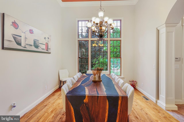 25 Mariner Ct, Ridgeley, WV 26753 - dining room with a chandelier, light wood-style flooring, baseboards, ornamental molding, and ornate columns