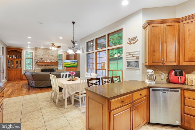 25 Mariner Ct, Ridgeley, WV 26753 - kitchen with dishwasher, a stone fireplace, a ceiling fan, brown cabinetry, and recessed lighting