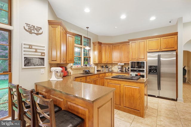25 Mariner Ct, Ridgeley, WV 26753 - kitchen with appliances with stainless steel finishes, a sink, a peninsula, tasteful backsplash, and a center island