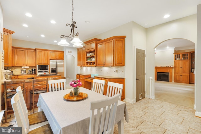 25 Mariner Ct, Ridgeley, WV 26753 - dining area featuring arched walkways, recessed lighting, a fireplace, light carpet, and light tile patterned floors