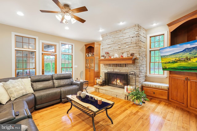 25 Mariner Ct, Ridgeley, WV 26753 - living room featuring light wood-type flooring, a ceiling fan, a stone fireplace, and recessed lighting