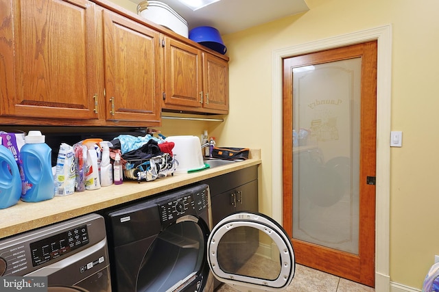 25 Mariner Ct, Ridgeley, WV 26753 - laundry area featuring washing machine and dryer, cabinet space, light tile patterned floors, and baseboards