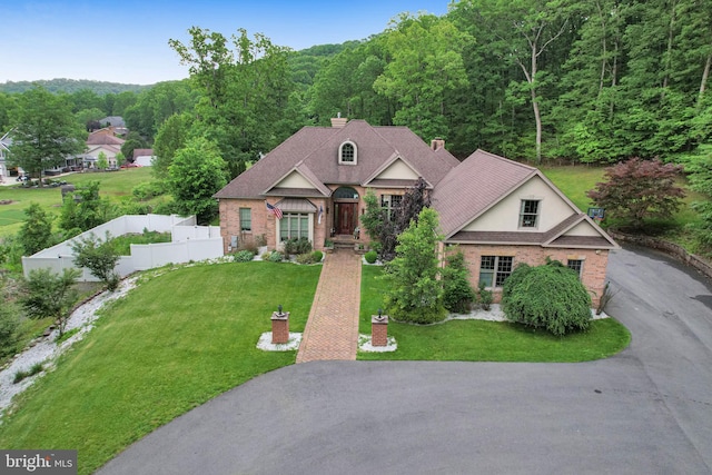 25 Mariner Ct, Ridgeley, WV 26753 - view of front of home with a wooded view, a chimney, driveway, and brick siding
