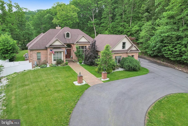 25 Mariner Ct, Ridgeley, WV 26753 - view of front of house featuring asphalt driveway, brick siding, a view of trees, and a chimney