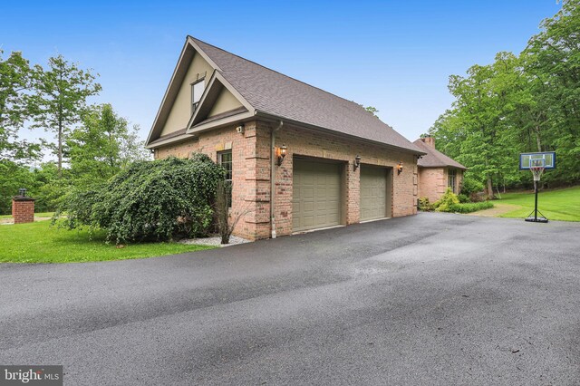 25 Mariner Ct, Ridgeley, WV 26753 - view of side of property with brick siding, driveway, a garage, a lawn, and roof with shingles