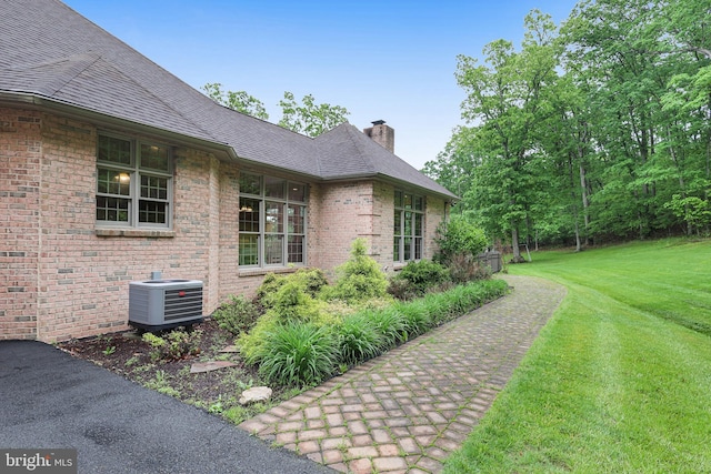 25 Mariner Ct, Ridgeley, WV 26753 - view of side of home with a chimney, central AC unit, a yard, and brick siding