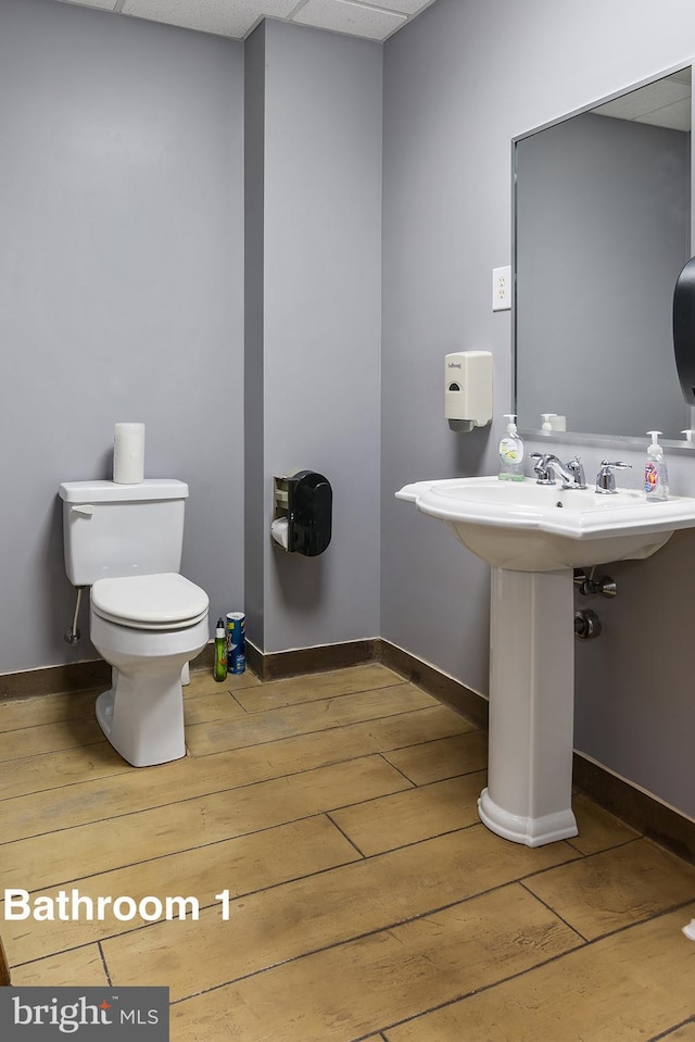 3 Howell Point Rd, Betterton, MD 21610 - half bath with hardwood / wood-style flooring, toilet, a paneled ceiling, and baseboards