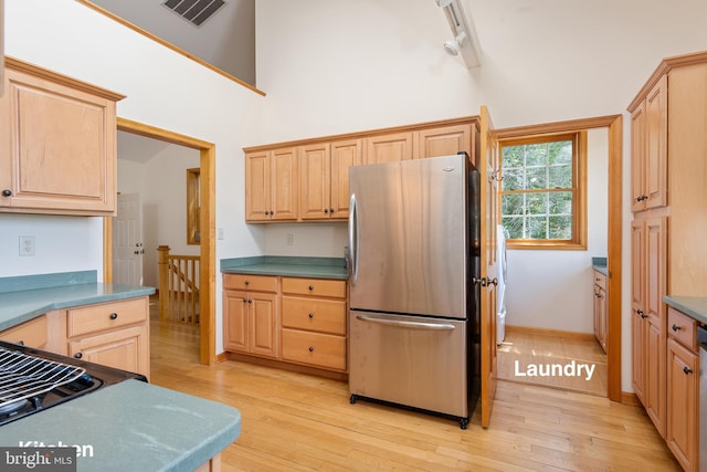 3 Howell Point Rd, Betterton, MD 21610 - kitchen with freestanding refrigerator, high vaulted ceiling, light brown cabinetry, light wood finished floors, and baseboards