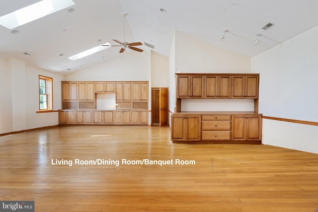 3 Howell Point Rd, Betterton, MD 21610 - kitchen with a skylight, high vaulted ceiling, light wood-style floors, a ceiling fan, and brown cabinetry