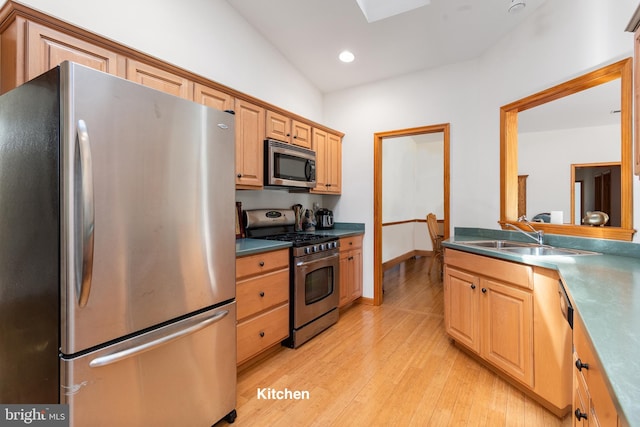 3 Howell Point Rd, Betterton, MD 21610 - kitchen with appliances with stainless steel finishes, a sink, light wood-style flooring, a skylight, and recessed lighting