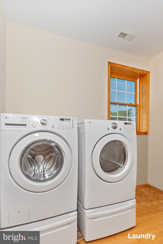 3 Howell Point Rd, Betterton, MD 21610 - laundry area with washer and clothes dryer, light wood-style flooring, and baseboards