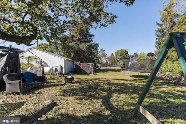 3 Howell Point Rd, Betterton, MD 21610 - view of yard with a trampoline and an outdoor fire pit