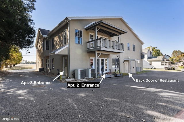 3 Howell Point Rd, Betterton, MD 21610 - view of front of home featuring a balcony, stucco siding, and central AC unit