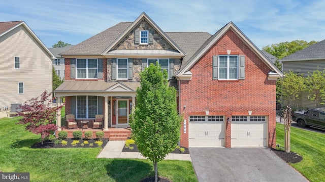 1504 Willow Branch Way, Severn, MD 21144 - traditional-style house with brick siding, a front lawn, driveway, a porch, and an attached garage
