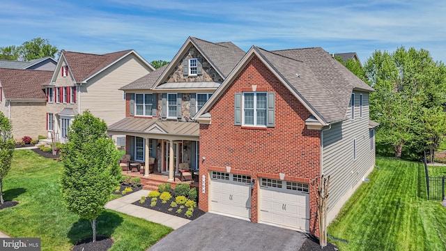 1504 Willow Branch Way, Severn, MD 21144 - view of front of property featuring a front yard, asphalt driveway, covered porch, an attached garage, and brick siding