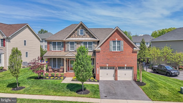 1504 Willow Branch Way, Severn, MD 21144 - view of front of home featuring brick siding, covered porch, asphalt driveway, and a front yard