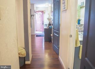 22 Erbitea Ln, New Castle, DE 19720 - hallway featuring dark wood-style floors and baseboards