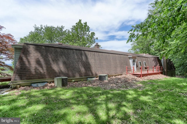 1236 Wood Rd, Hummelstown, PA 17036 - back of property with a deck, a lawn, central AC unit, and a shingled roof