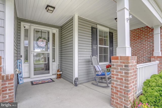 38623 Longs Chapel Ln, Millville, DE 19967 - doorway to property with covered porch and brick siding
