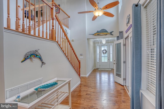 38623 Longs Chapel Ln, Millville, DE 19967 - entrance foyer with a high ceiling, baseboards, stairs, wood finished floors, and a ceiling fan
