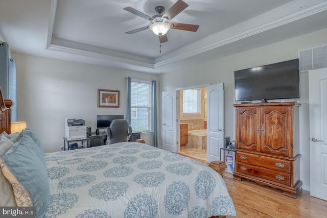 38623 Longs Chapel Ln, Millville, DE 19967 - bedroom featuring light wood-style floors, a tray ceiling, ensuite bathroom, a desk, and ceiling fan
