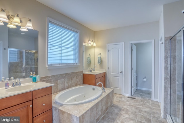38623 Longs Chapel Ln, Millville, DE 19967 - full bath with a stall shower, two vanities, and a jetted tub