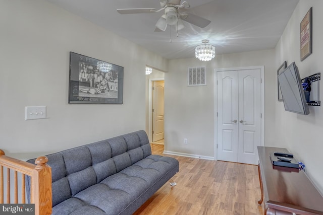 38623 Longs Chapel Ln, Millville, DE 19967 - living area featuring a ceiling fan, light wood-type flooring, a chandelier, and baseboards