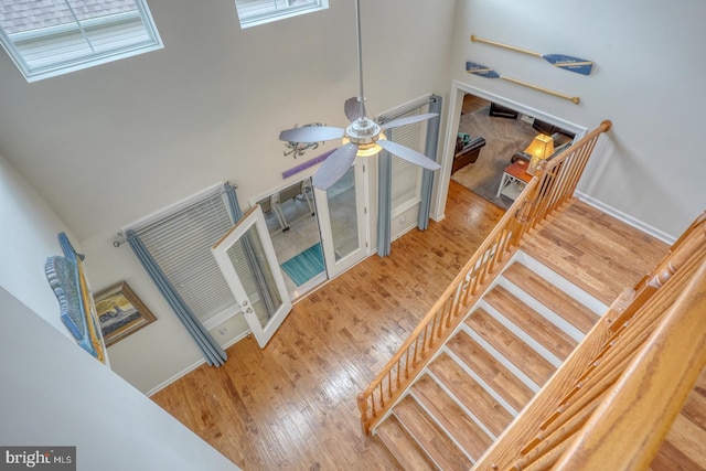38623 Longs Chapel Ln, Millville, DE 19967 - stairway with wood finished floors, ceiling fan, and baseboards