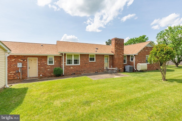 113 Kendallwood Dr, Fredericksburg, VA 22405 - back of property with cooling unit, a patio area, roof with shingles, a yard, and a chimney