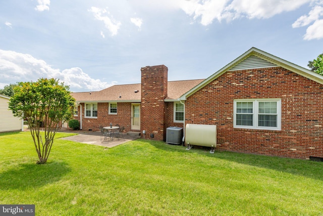 113 Kendallwood Dr, Fredericksburg, VA 22405 - back of property with cooling unit, a chimney, brick siding, a patio, and a yard