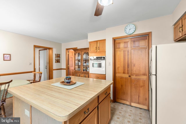113 Kendallwood Dr, Fredericksburg, VA 22405 - kitchen with white appliances, a ceiling fan, a center island, and light flooring