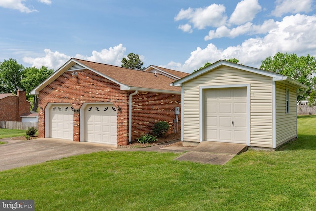 113 Kendallwood Dr, Fredericksburg, VA 22405 - view of front of home with brick siding, a front yard, an attached garage, a shingled roof, and an outbuilding