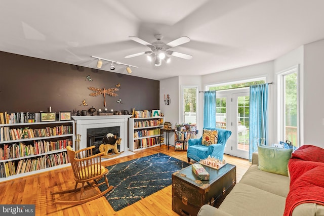 419 Westside Station Dr, Winchester, VA 22601 - living area with rail lighting, a ceiling fan, a fireplace with flush hearth, and wood finished floors