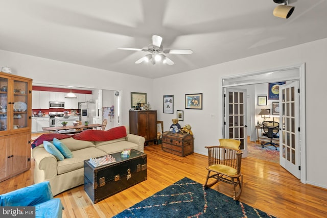 419 Westside Station Dr, Winchester, VA 22601 - living room with light wood-type flooring, french doors, and ceiling fan