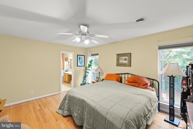 419 Westside Station Dr, Winchester, VA 22601 - bedroom with baseboards, light wood-style floors, ceiling fan, and connected bathroom