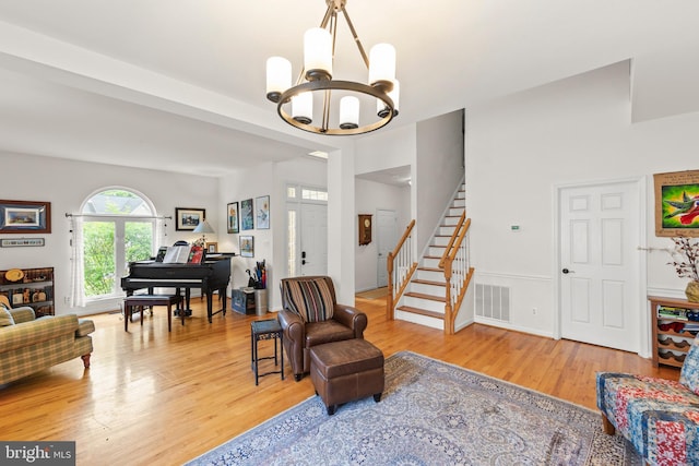 419 Westside Station Dr, Winchester, VA 22601 - living area with wood finished floors, a chandelier, and stairs