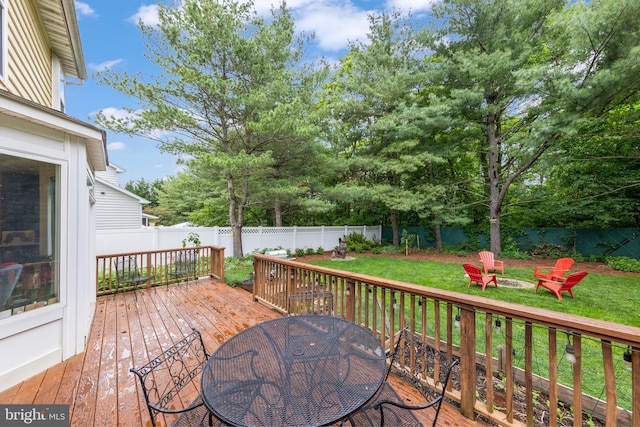 419 Westside Station Dr, Winchester, VA 22601 - wooden terrace with outdoor dining space, a fire pit, and view of wooded area