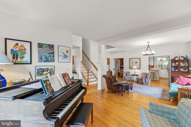 419 Westside Station Dr, Winchester, VA 22601 - living area featuring a chandelier, wood finished floors, and stairs