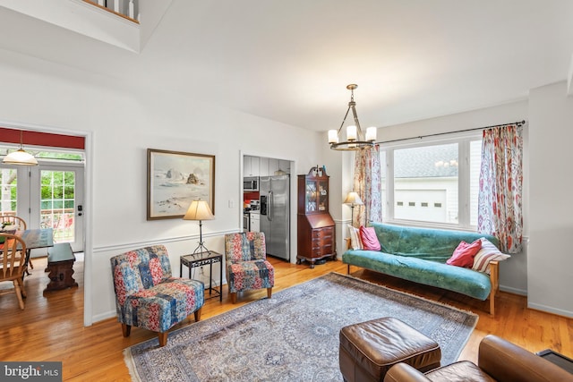 419 Westside Station Dr, Winchester, VA 22601 - living area featuring a chandelier, light wood-type flooring, and baseboards