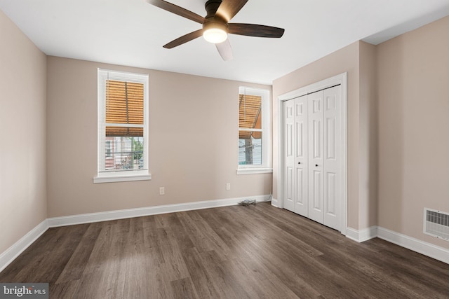 2032 S 21st St, Philadelphia, PA 19145 - unfurnished bedroom with dark wood finished floors, multiple windows, baseboards, and a closet