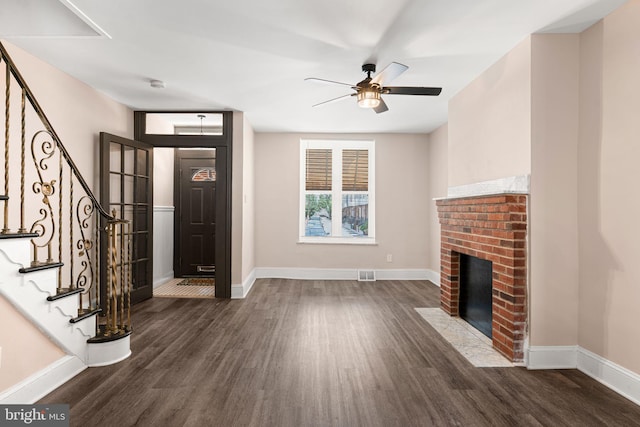 2032 S 21st St, Philadelphia, PA 19145 - foyer featuring wood finished floors, stairs, a ceiling fan, and a brick fireplace