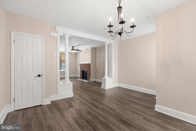 2032 S 21st St, Philadelphia, PA 19145 - unfurnished living room featuring ornate columns, dark wood finished floors, a fireplace, baseboards, and a chandelier