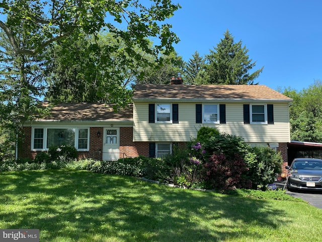 1634 Highpoint Ln, Aston, PA 19014 - split level home featuring a front yard, a chimney, brick siding, and a carport