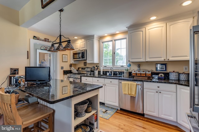 336 Miller St, Winchester, VA 22601 - kitchen with appliances with stainless steel finishes, a sink, a kitchen breakfast bar, open shelves, and white cabinetry