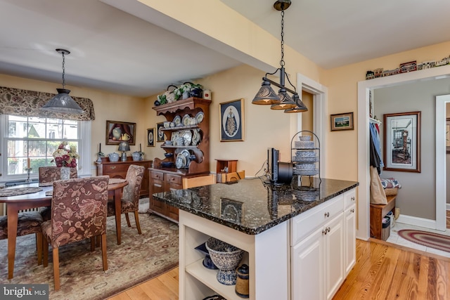 336 Miller St, Winchester, VA 22601 - kitchen featuring open shelves, light wood-style flooring, white cabinetry, dark stone countertops, and decorative light fixtures